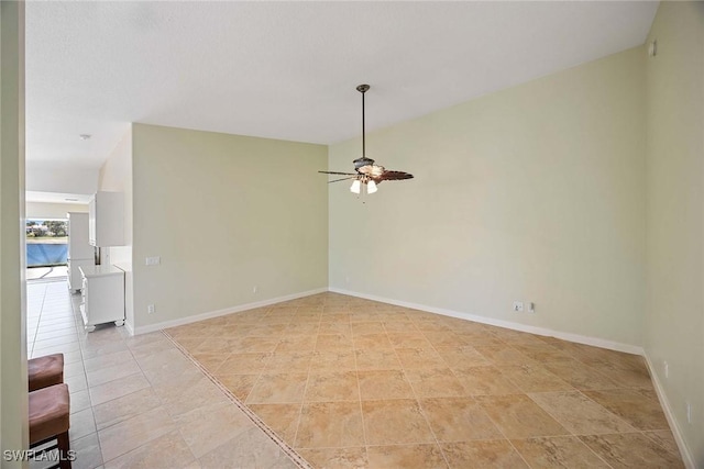 unfurnished room featuring a ceiling fan and baseboards