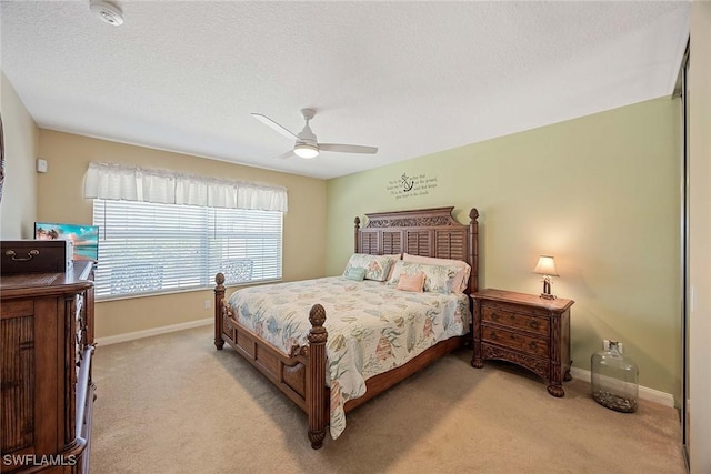 bedroom featuring a ceiling fan, baseboards, and light colored carpet