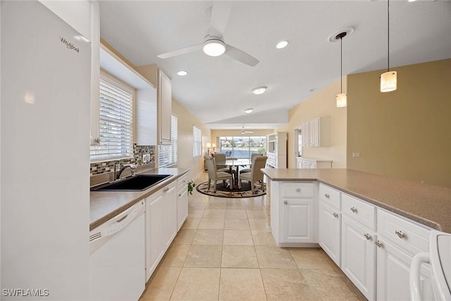 kitchen featuring white cabinetry, tasteful backsplash, a sink, and dishwasher