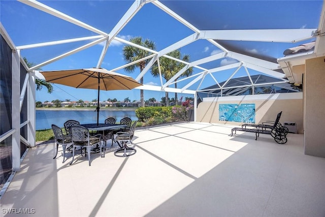 view of patio / terrace with outdoor dining area, a water view, and a lanai