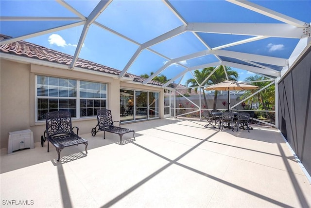 view of patio with a lanai and outdoor dining space