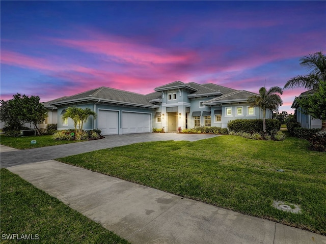 14243 Galley Ct, Naples, FL 34114 - view of front of home with a yard, an attached garage, driveway, and a tile roof
