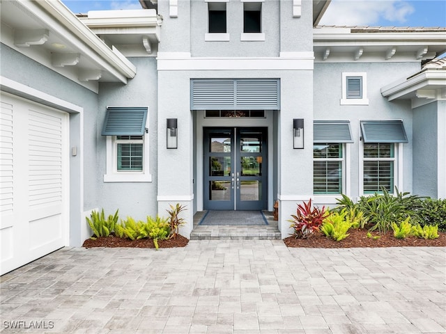 14243 Galley Ct, Naples, FL 34114 - view of exterior entry with french doors and stucco siding