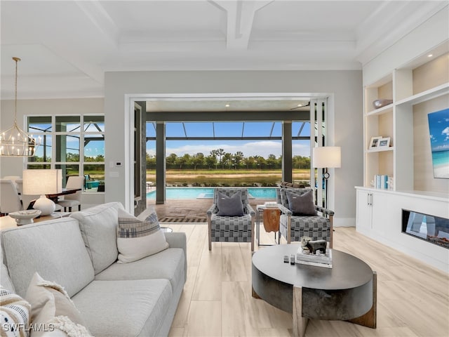 14243 Galley Ct, Naples, FL 34114 - living room featuring an inviting chandelier, built in features, a glass covered fireplace, beam ceiling, and coffered ceiling