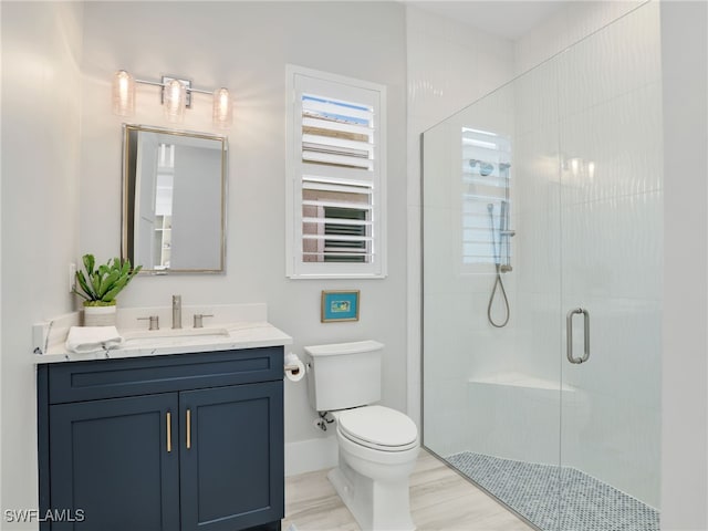 14243 Galley Ct, Naples, FL 34114 - bathroom featuring vanity, wood finished floors, toilet, baseboards, and a stall shower