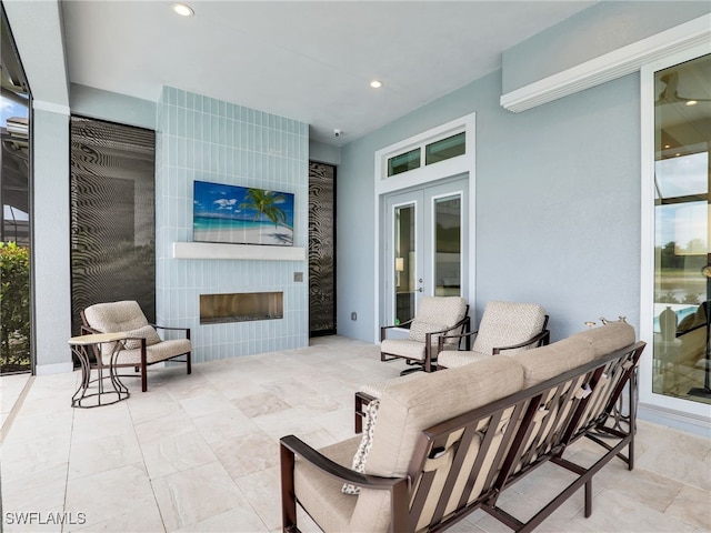 14243 Galley Ct, Naples, FL 34114 - view of patio / terrace featuring french doors and a fireplace
