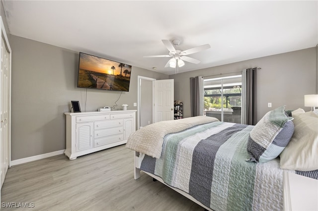 bedroom featuring light wood finished floors, baseboards, and a ceiling fan