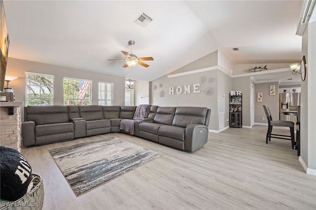 living room with ceiling fan, light wood-style flooring, baseboards, and vaulted ceiling