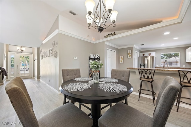 dining space featuring a chandelier, light wood-style flooring, baseboards, ornamental molding, and recessed lighting