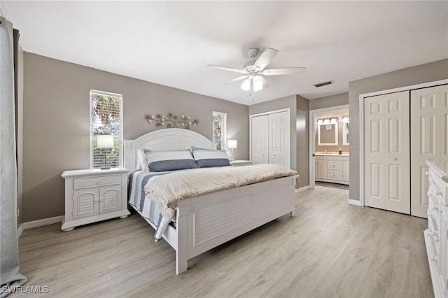 bedroom featuring two closets, light wood-type flooring, baseboards, and a ceiling fan