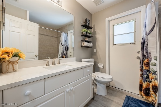 full bathroom with wood finished floors, vanity, toilet, and a shower with curtain