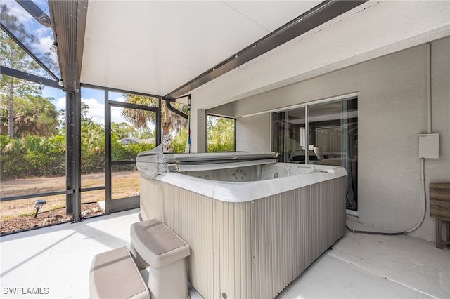 sunroom featuring a hot tub