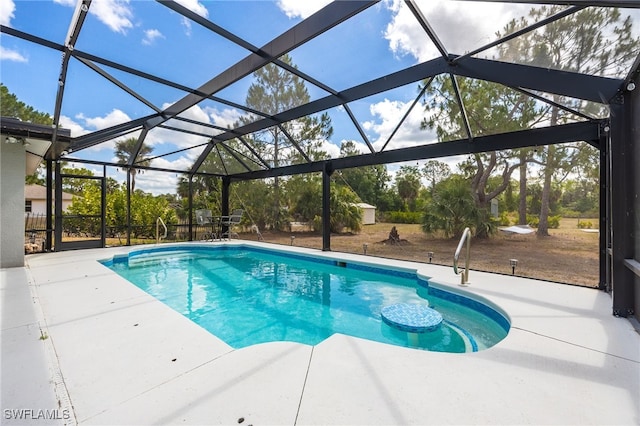 swimming pool with a patio area and glass enclosure
