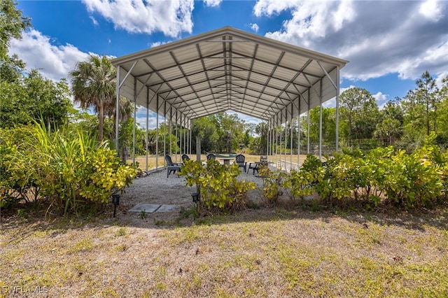 view of yard featuring a carport and a patio area