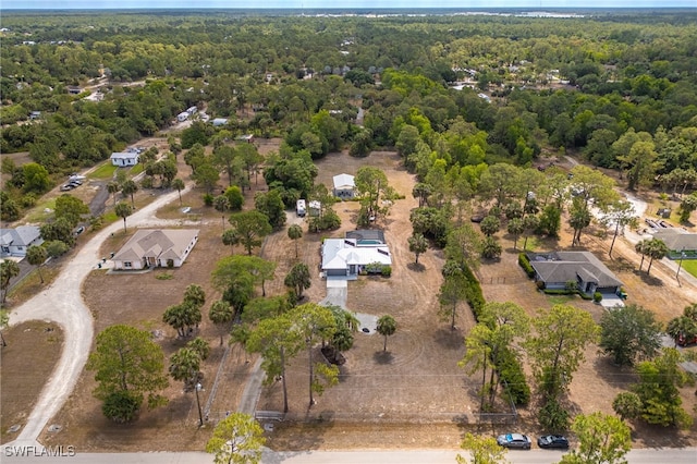 view of property location with a heavily wooded area