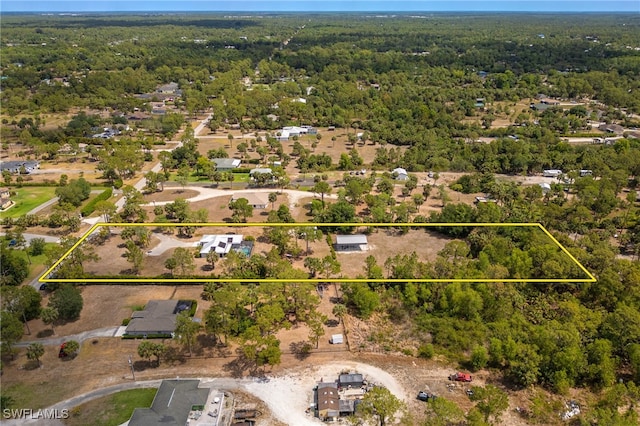 aerial view of property's location with a heavily wooded area and property boundaries highlighted