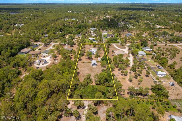 aerial overview of property's location featuring a heavily wooded area and property parcel outlined