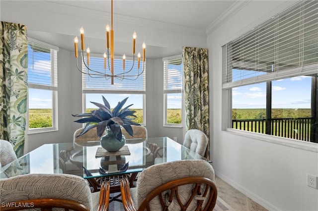 dining room featuring an inviting chandelier, baseboards, and crown molding