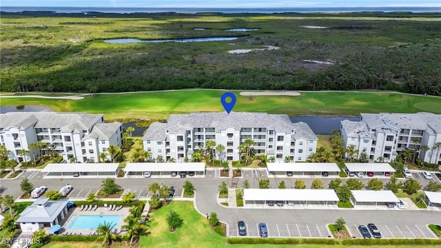 birds eye view of property with a water view and golf course view