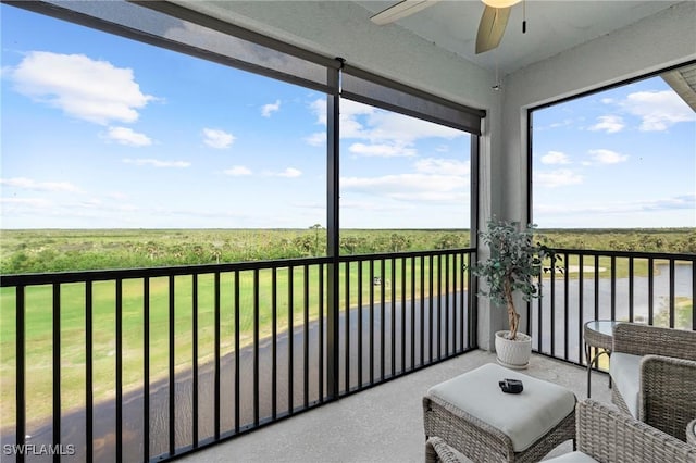 sunroom featuring ceiling fan