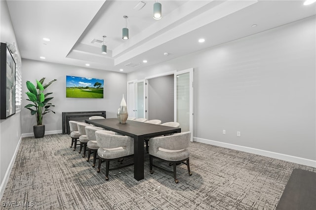 carpeted dining space with recessed lighting, baseboards, a tray ceiling, and visible vents