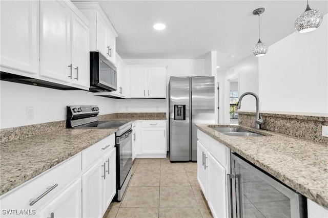kitchen with a sink, white cabinetry, beverage cooler, hanging light fixtures, and appliances with stainless steel finishes