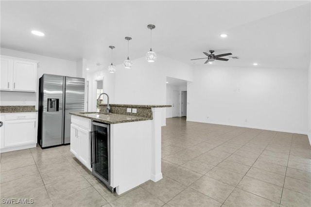 kitchen with a sink, light tile patterned flooring, a ceiling fan, beverage cooler, and stainless steel fridge with ice dispenser