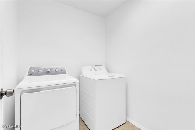 laundry room featuring washing machine and dryer and laundry area