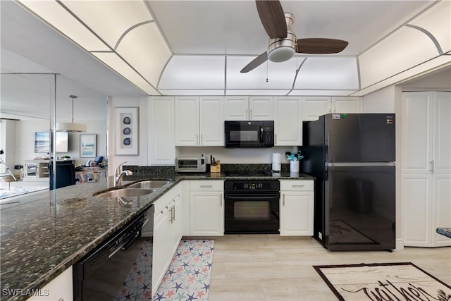 260 Seaview Ct Unit 402, Marco Island, FL 34145 - kitchen featuring a sink, white cabinetry, dark stone counters, and black appliances