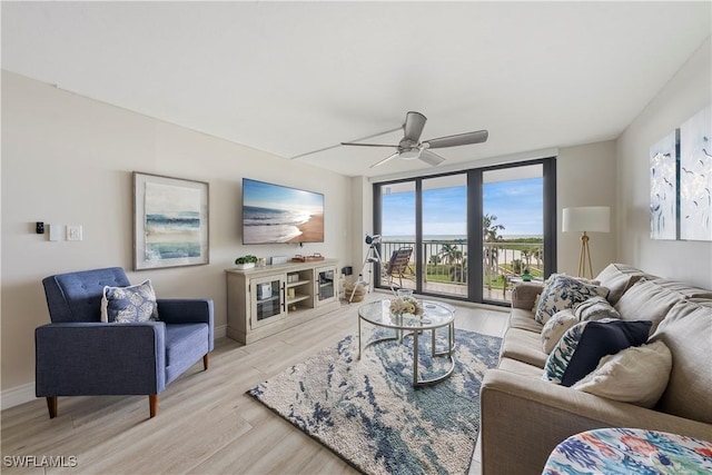 260 Seaview Ct Unit 402, Marco Island, FL 34145 - living area with baseboards, ceiling fan, and light wood-type flooring
