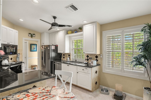 4748 San Carlo Ct, Naples, FL 34109 - kitchen with stainless steel dishwasher, electric range oven, visible vents, a sink, and black microwave