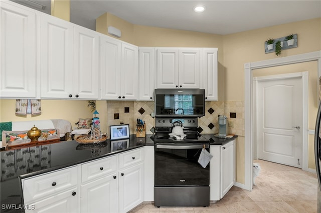 4748 San Carlo Ct, Naples, FL 34109 - kitchen with white cabinets, dark countertops, and electric stove