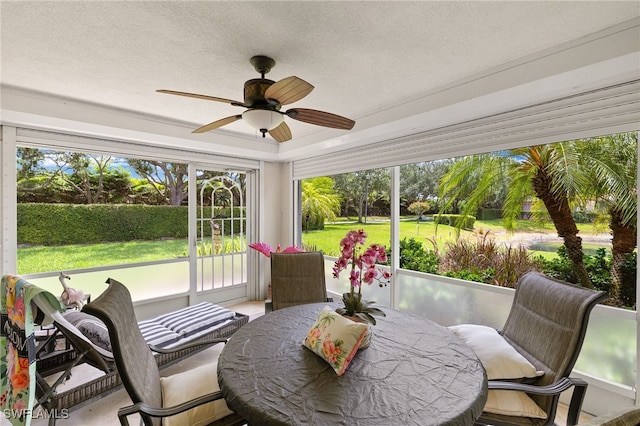 4748 San Carlo Ct, Naples, FL 34109 - sunroom featuring a ceiling fan, outdoor dining area, and a textured ceiling