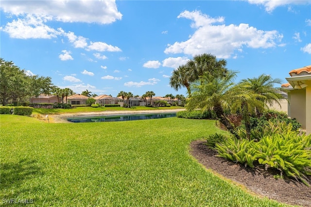 4748 San Carlo Ct, Naples, FL 34109 - view of community featuring a water view, a residential view, and a lawn