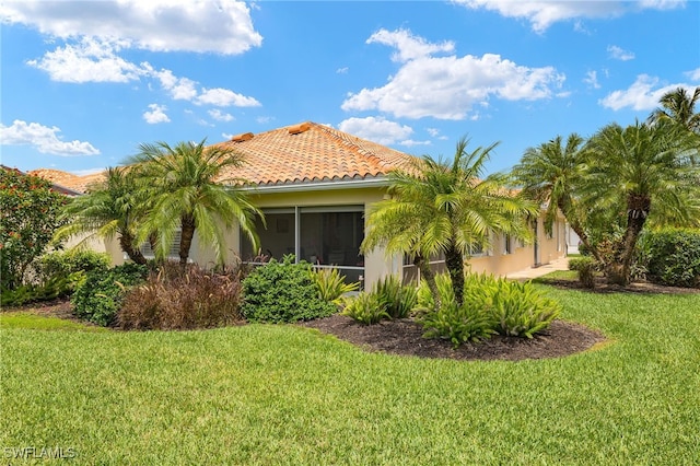4748 San Carlo Ct, Naples, FL 34109 - view of property exterior with a yard, a tiled roof, and stucco siding