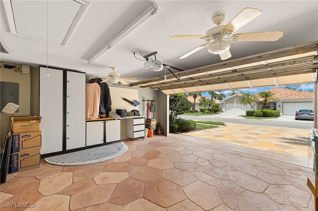 4748 San Carlo Ct, Naples, FL 34109 - garage featuring electric panel, a ceiling fan, and a garage door opener