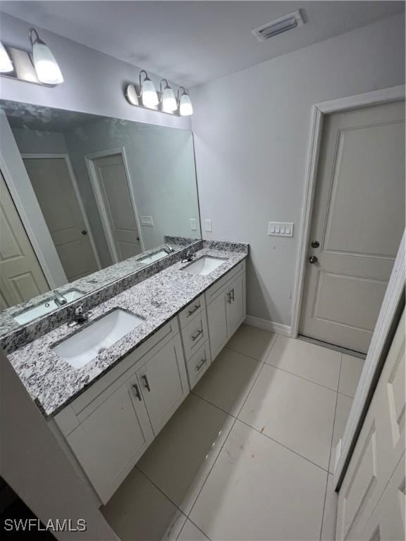 full bath with tile patterned floors, visible vents, and a sink