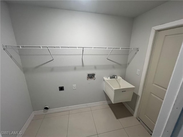 laundry room with laundry area, baseboards, hookup for a washing machine, electric dryer hookup, and a sink