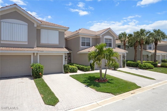 11016 Mill Creek Way Unit 2403, Fort Myers, FL 33913 - townhome / multi-family property featuring a tiled roof, stucco siding, and driveway