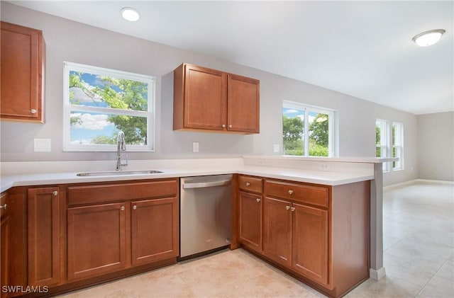 1821 SW 25th St, Cape Coral, FL 33914 - kitchen featuring a peninsula, brown cabinetry, a sink, and dishwasher