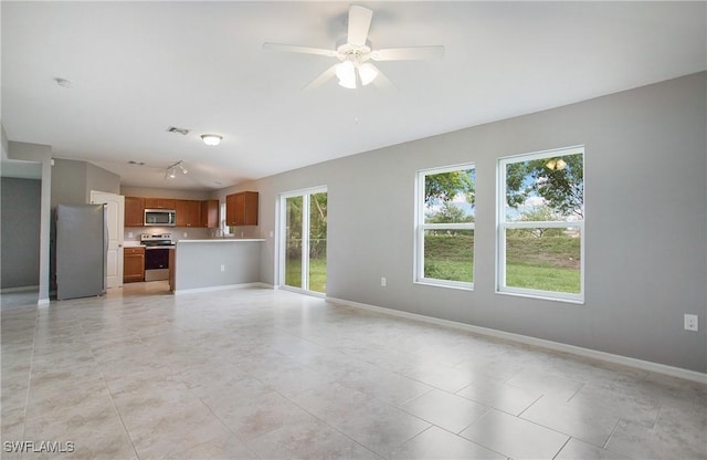 1821 SW 25th St, Cape Coral, FL 33914 - unfurnished living room with ceiling fan, visible vents, track lighting, baseboards, and light tile patterned flooring