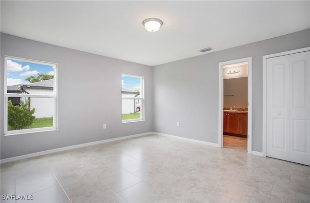 1821 SW 25th St, Cape Coral, FL 33914 - unfurnished bedroom with baseboards, multiple windows, and visible vents