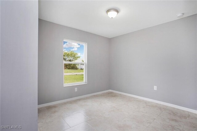 1821 SW 25th St, Cape Coral, FL 33914 - empty room featuring baseboards and light tile patterned flooring
