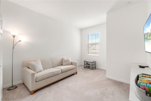 carpeted living room featuring baseboards