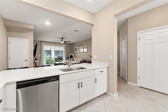 kitchen featuring stainless steel dishwasher, ceiling fan, a sink, open floor plan, and a peninsula