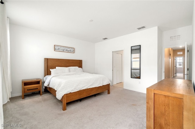bedroom featuring light colored carpet, baseboards, and visible vents