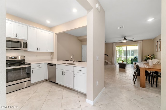 kitchen with a sink, visible vents, light countertops, appliances with stainless steel finishes, and light tile patterned flooring