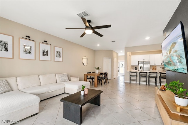 living room featuring light tile patterned floors, ceiling fan, recessed lighting, and visible vents