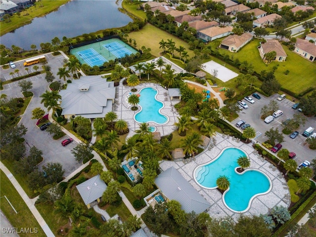 birds eye view of property with a water view