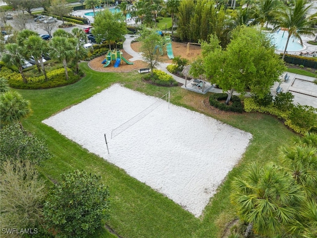 view of property's community with playground community, a lawn, and volleyball court